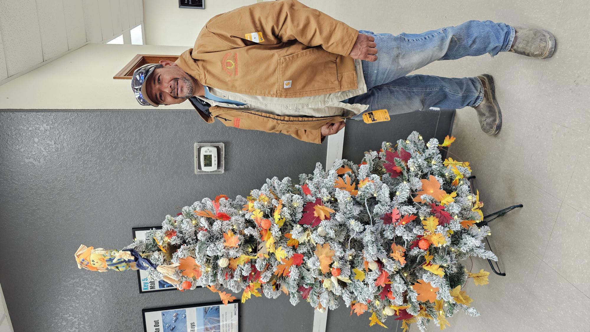 Coastal Plains Trucking employee Gerardo Cantu celebrates his 10-year anniversary with a gifted Carhart jacket.