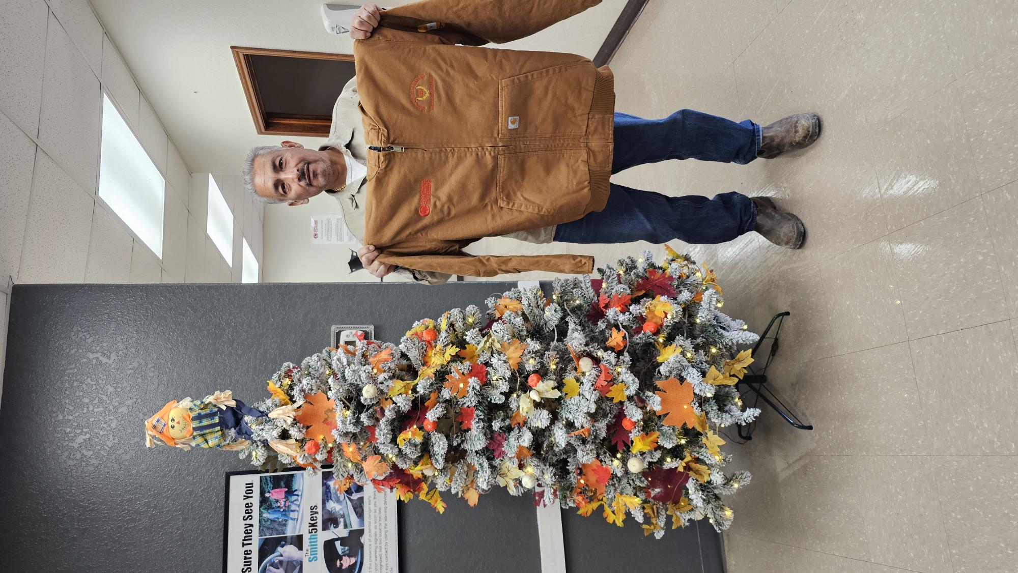 Coastal Plains Trucking employee Jose Lopez celebrates his 10-year anniversary with a gifted Carhart jacket.